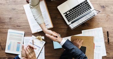 Business people shaking hands together